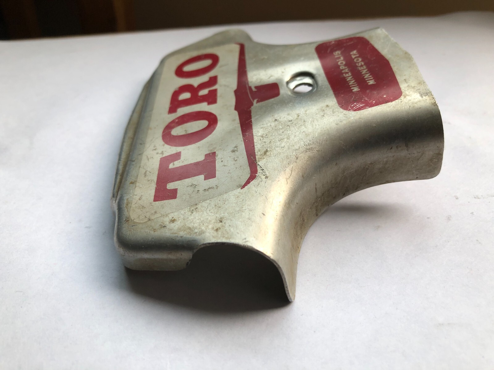 TORO Metal Marker for a Lawn Mower with the words “Clutch & Throttle” on top