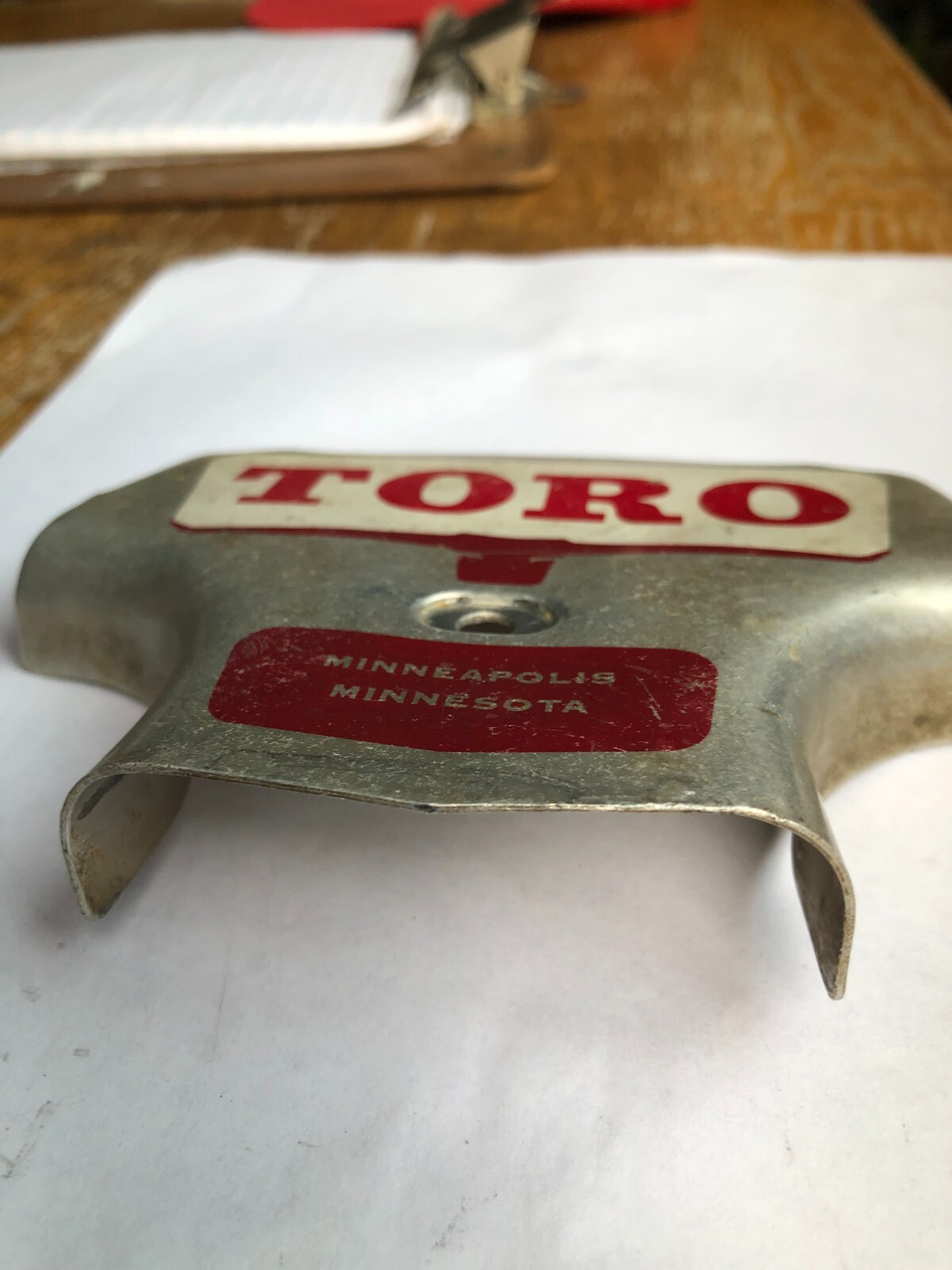 TORO Metal Marker for a Lawn Mower with the words “Clutch & Throttle” on top