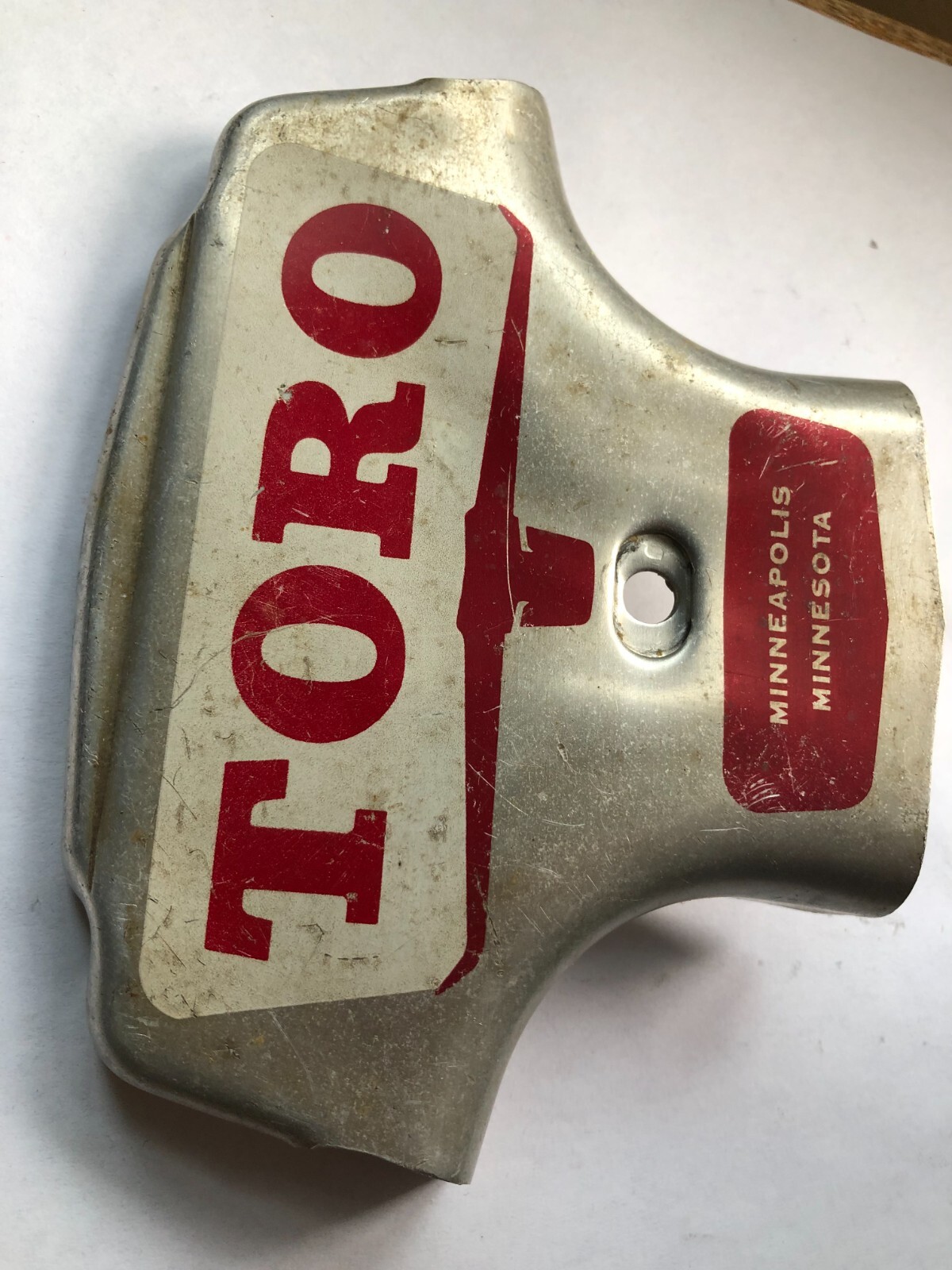 TORO Metal Marker for a Lawn Mower with the words “Clutch & Throttle” on top