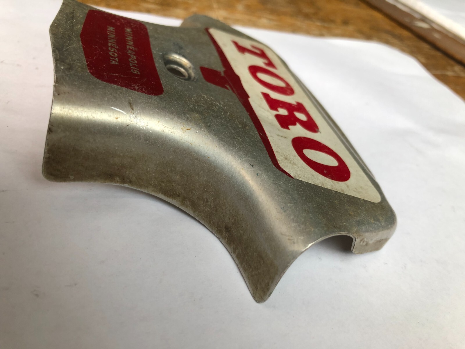 TORO Metal Marker for a Lawn Mower with the words “Clutch & Throttle” on top