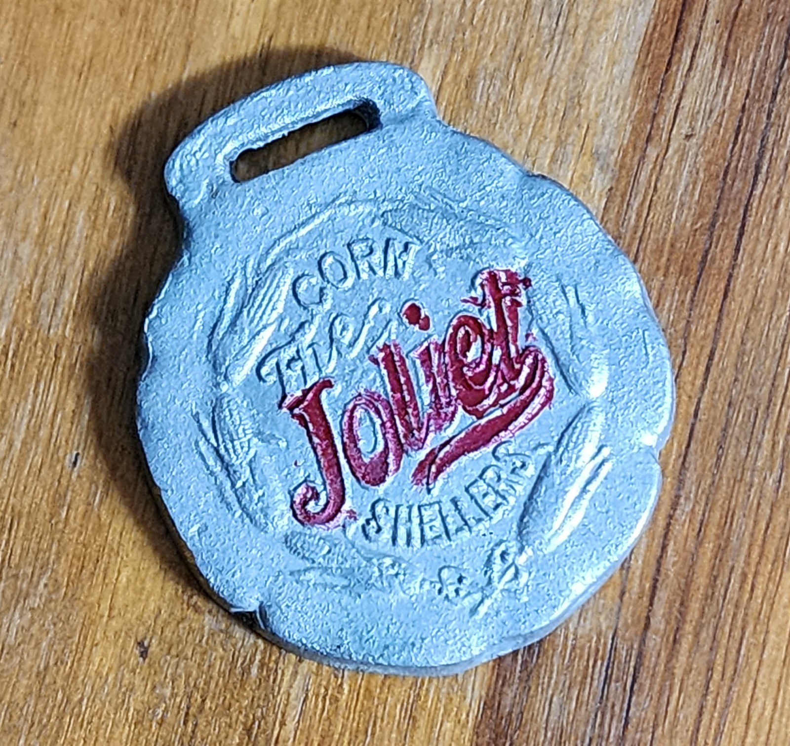 ANTIQUE JOLIET CORN SHELLERS METAL WATCH FOB NOT HOW CHEAP BUT HOW GOOD 1-5/8″