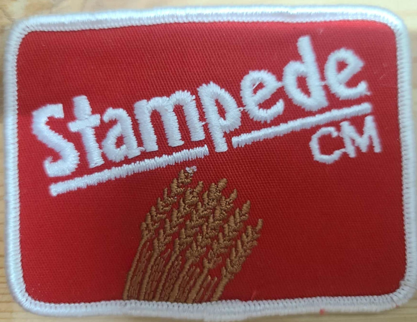 “Stampede CM Embroidered Sew-On Patch Red and White”