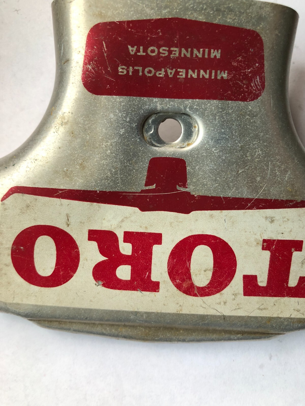 TORO Metal Marker for a Lawn Mower with the words “Clutch & Throttle” on top