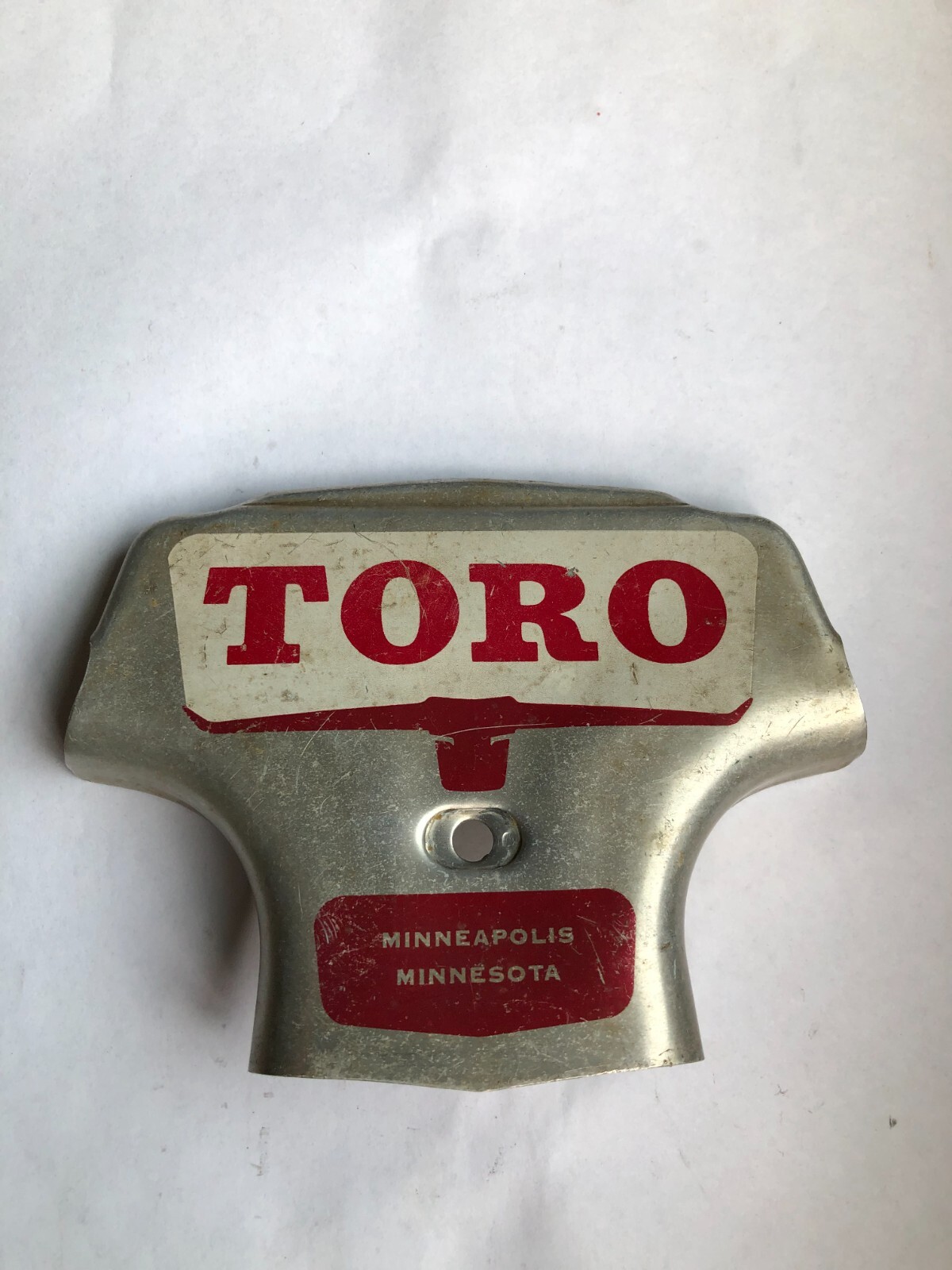 TORO Metal Marker for a Lawn Mower with the words “Clutch & Throttle” on top