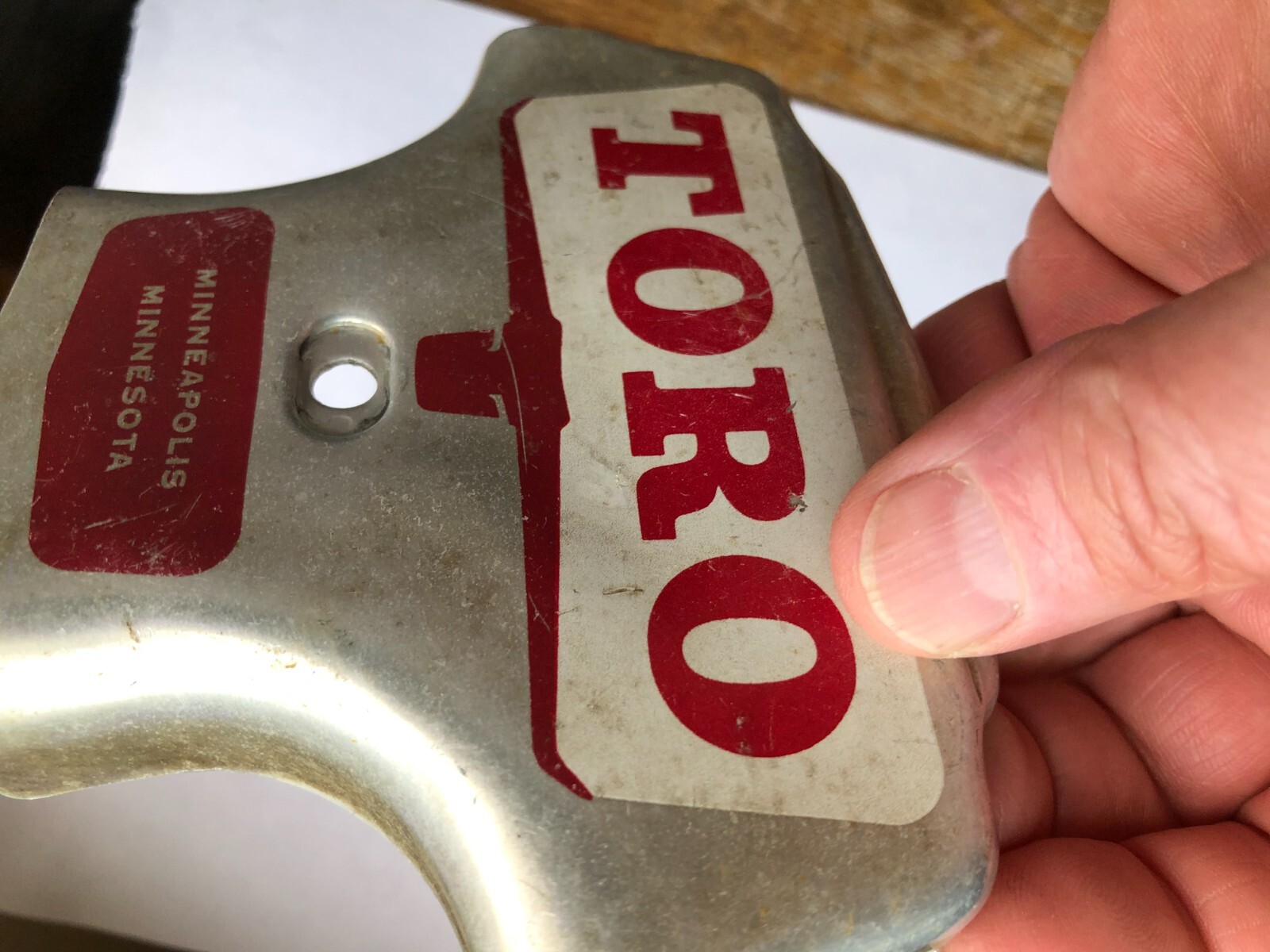 TORO Metal Marker for a Lawn Mower with the words “Clutch & Throttle” on top