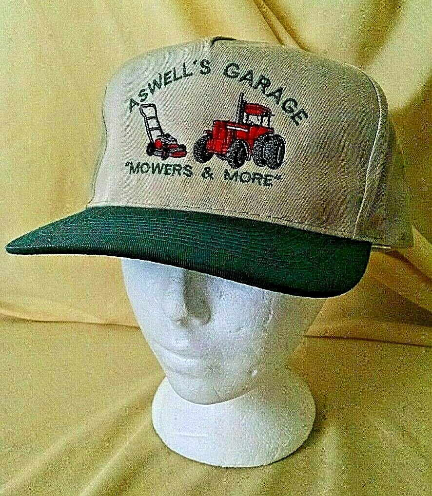 ASWELL’S GARAGE HAT MOWERS & MORE GRASS CUTTER TRACTOR BEIGE GREEN OTTO ADJBL.